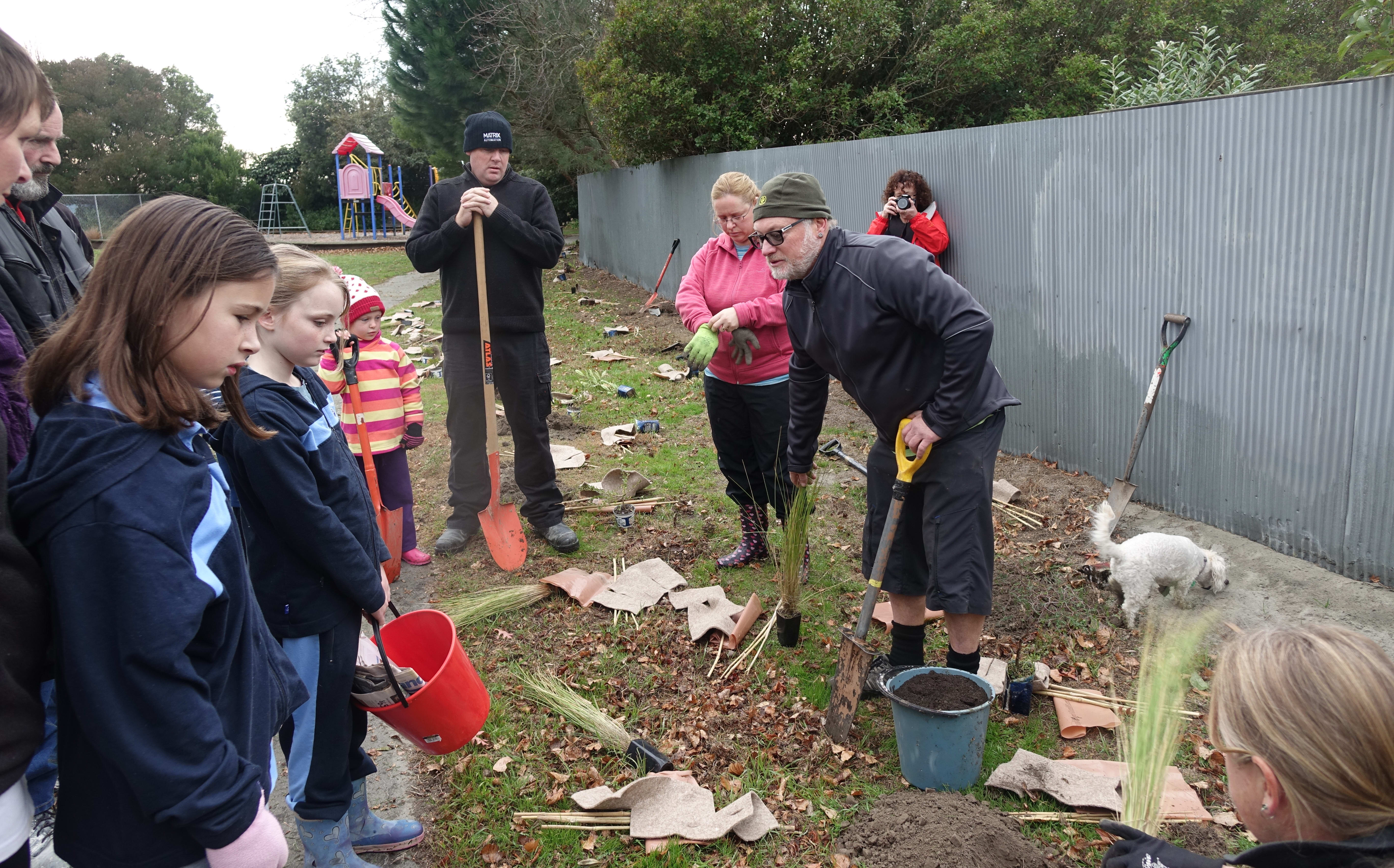 The volunteers gathered for some tips on planting before they get started.
