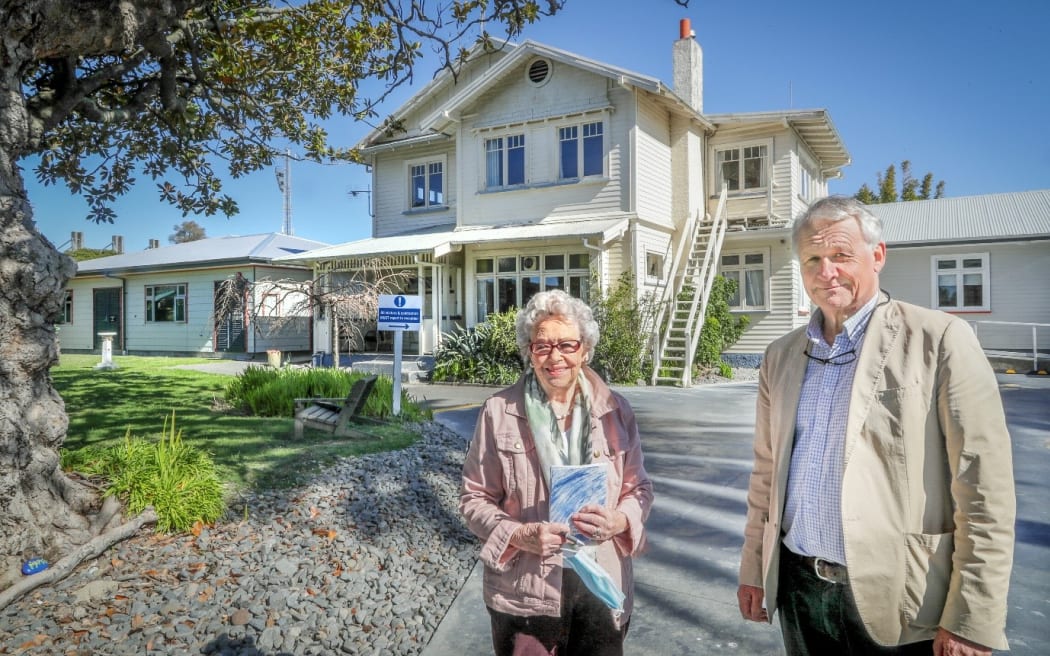 image of Erica Toomey and Dr Tim Bevin in front of Springhill Addiction Treatment Centre in Napier,  2020 before the building was demolished for a more purpose built facility.