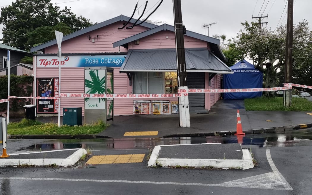 Police outside a dairy in the Auckland suburb of Sandringham where a man was fatally stabbed.