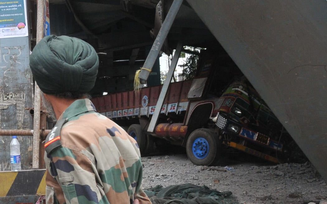 An Indian Army rescue worker surveys the wreckage.