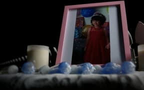 Candles, photos and flowers have been placed at the home where Maggie Renee Watson was found dead.