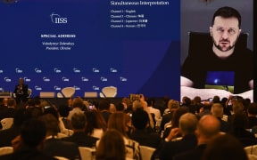 Ukraine's President Volodymyr Zelensky (on screen) addresses participants at the Shangri-La Dialogue summit virtually via a video link in Singapore on 11 June 2022.