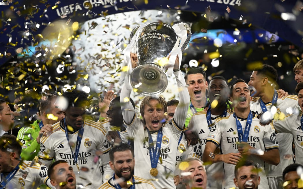Real Madrid captain Luka Modric lifts the trophy to celebrate their victory at the end of the UEFA Champions League final against Borussia Dortmund.