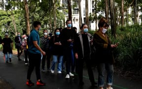 Sydneysiders queue outside a vaccination centre in Sydney on June 29, 2021, as about 10 million Australians have been ordered into lockdown.