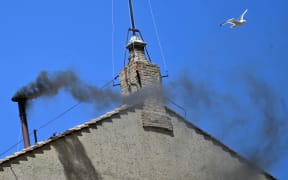 Black smoke rising from the chimney of the Sistine Chapel signals that cardinals failed to elect a new pope during their first vote on 8 May, 2025, during the conclave in the Vatican.