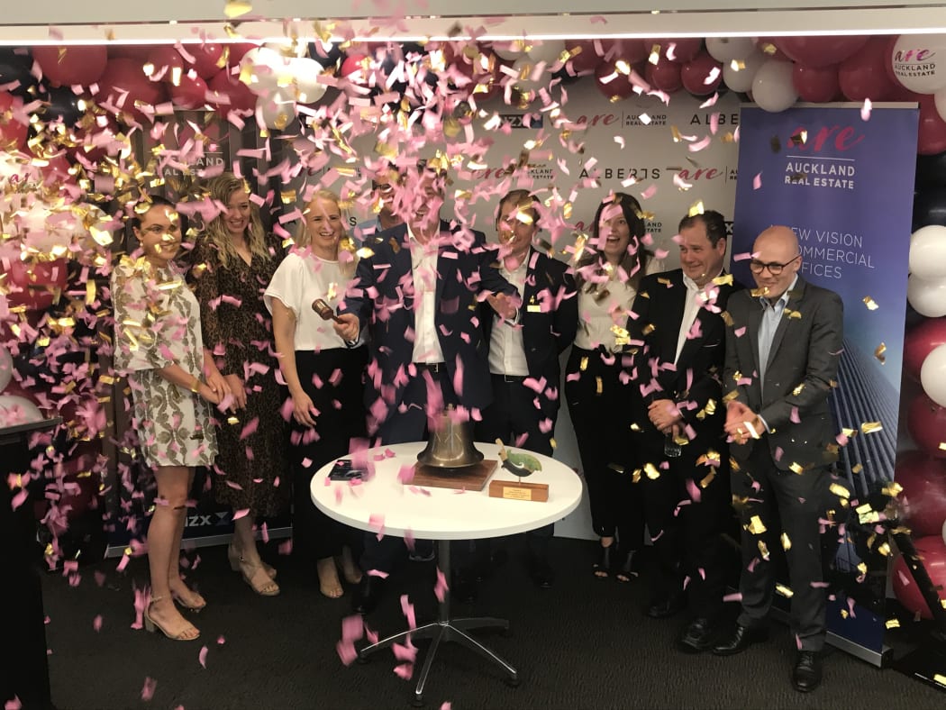 Auckland Real Estate Trust independent director, Nick Hargreaves rings the bell to commemorate the start of trading