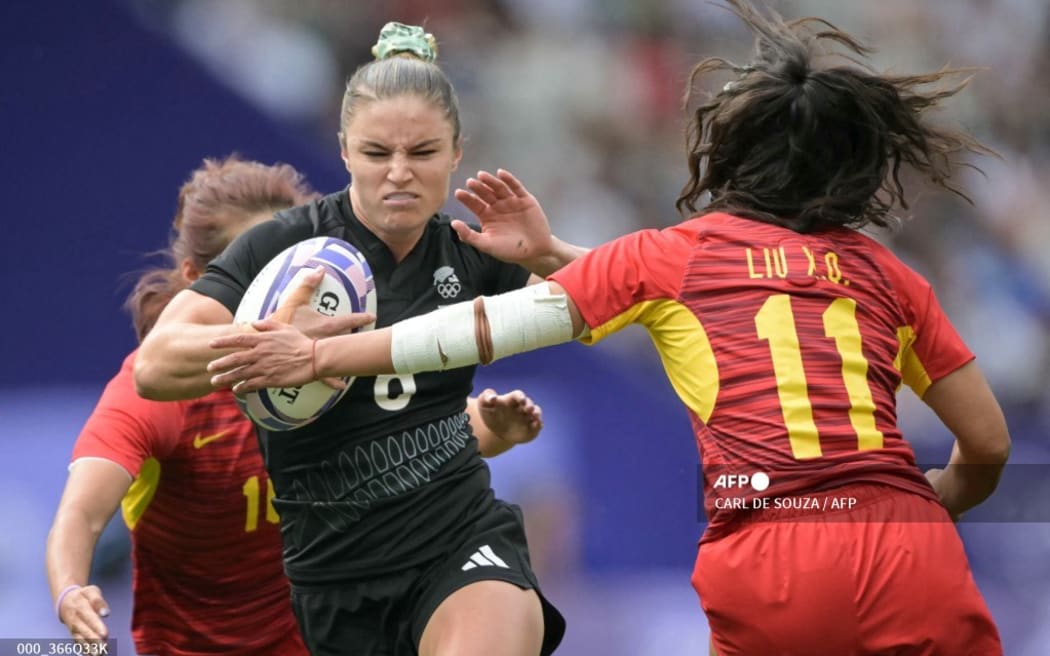 New Zealand's Michaela Blyde (L) is chased by China's Liu Xiaoqian (R) during the women's pool A rugby sevens match between New Zealand and China during the Paris 2024 Olympic Games at the Stade de France in Saint-Denis on July 28, 2024.