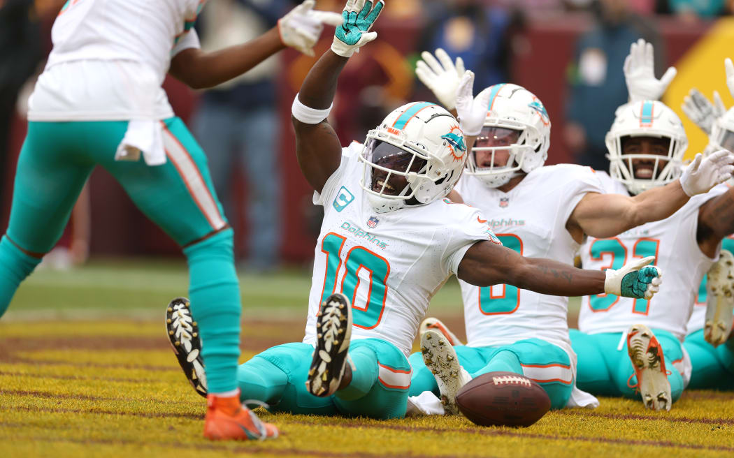 LANDOVER, MARYLAND - DECEMBER 03: Wide receiver Tyreek Hill #10 of the Miami Dolphins celebrates after catching a first half touchdown pass against the Washington Commanders at FedExField on December 03, 2023 in Landover, Maryland. (Photo by Rob Carr/Getty Images)