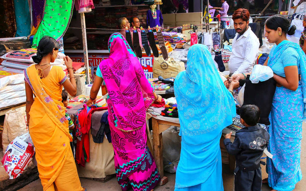 Women browsing a market stall in Agra city, Uttar Pradesh, India