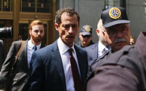 Anthony Weiner leaves court in Manhattan after pleading guilty to one charge of sending obscene messages to a minor.