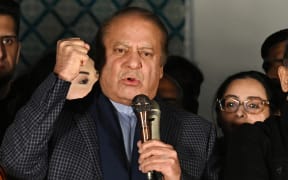 Pakistan's former Prime Minister Nawaz Sharif and leader of the Pakistan Muslim League Nawaz (PMLN) party speaks with supporters in Lahore on February 9, 2024, a day after Pakistan's national elections. Candidates loyal to jailed former prime minister Imran Khan edged ahead in Pakistan's election Friday, in front of the two dynastic parties believed favoured by the military, as the vote count entered its final leg. (Photo by Aamir QURESHI / AFP)