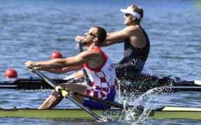 Mahe Drysdale edges ahead of Croatia's Damir Martin in the men's sculls final.
