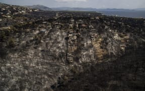 An aerial view shows a burnt area following a wildfire in the village of Mati, near Athens.