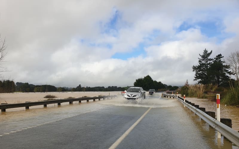 A car drives through flooding in Northland on 18 July.