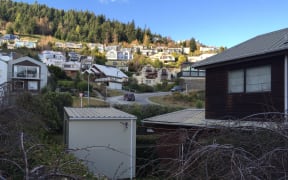 A portable sleep out cabin dropped into rental house garden.