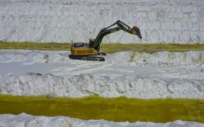 Aerial view of brine ponds and processing areas of the lithium mine of the Chilean company SQM (Sociedad Quimica Minera) in the Atacama Desert, Calama, Chile, on September 12, 2022. The turquoise glimmer of open-air pools meets the dazzling white of a seemingly endless salt desert where hope and disillusionment collide in Latin America's "lithium triangle." A key component of batteries used in electric cars, demand has exploded for the "white gold" found in Argentina, Bolivia and Chile in quantities larger than anywhere else in the world. (Photo by Martin BERNETTI / AFP)