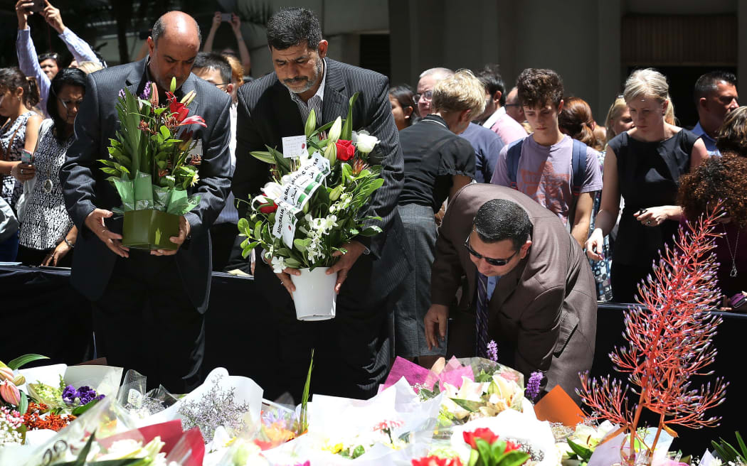 Thousands of people have laid flowers near the Martin Place cafe.