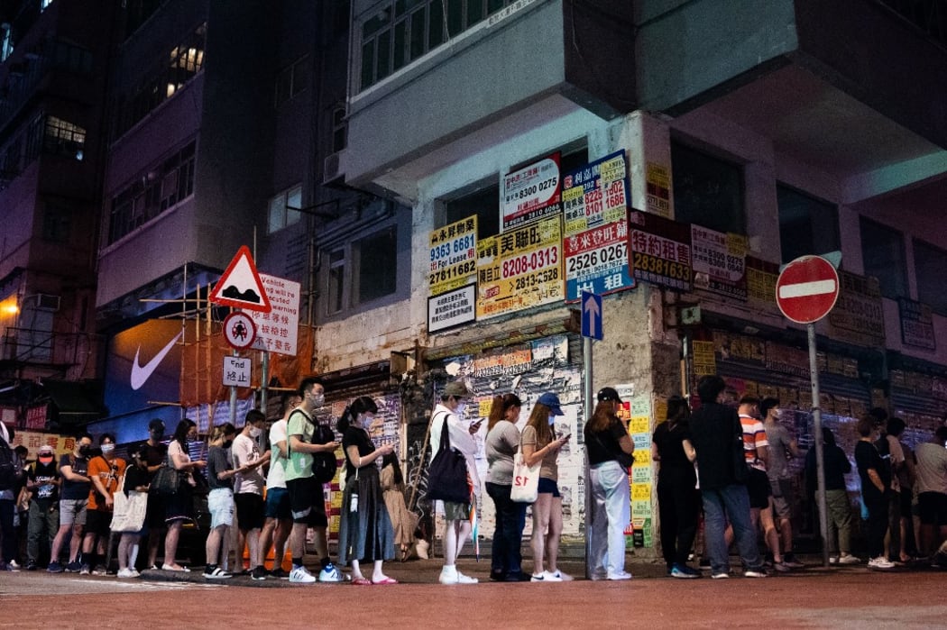 People queue for the first batch of Apple Daily newspaper to be delivered at Mong Kok, Hong Kong early on June 24, 2021, which is the last edition of the pro-democracy paper.