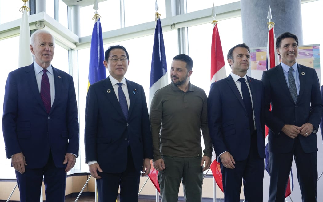 (L to R) US President Joe Biden, Japan's Prime Minister Fumio Kishida, Ukraine's President Volodymyr Zelensky, France's President Emmanuel Macron, Canada's Prime Minister Justin Trudeau pose for a family photo ahead of a working session on Ukraine during the G7 Leaders' Summit in Hiroshima on May 21, 2023. (Photo by Susan Walsh / POOL / AFP)