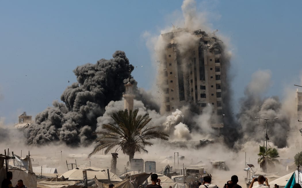 Smoke billows during Israeli strikes on the Mushtaha Tower in Gaza City on September 5, 2025, amid the war between Israel and the Hamas militant movement. The Israeli military said it struck a high-rise in Gaza City on September 5, shortly after announcing it would target tall buildings identified as being used by Hamas ahead of its forces' planned conquest of the urban hub. (Photo by Omar AL-QATTAA / AFP)