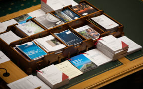 Budget 2023 documents sit on the table in Parliament's debating chamber.