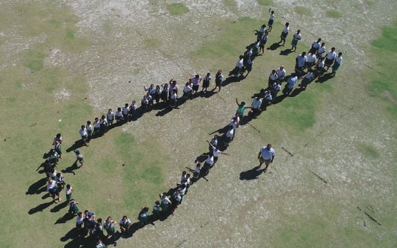 School children at Nukunonu school form whale shark shape