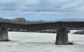 A 610m-long rail bridge over the Rangitata River, South Canterbury, sags after flood water washed away one of 34 piers. PHOTO: CONNOR HALEY