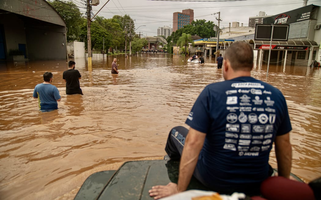 A volunteer group of off-road drivers helps rescue people in flood-hit areas in Porto Alegre, Rio Grande do Sul State, Brazil, on 4 May, 2024.