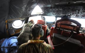 Crew of an Australian Air Force Orion searching in the southern Indian Ocean.