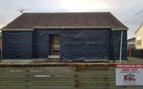 A state house in Naenae has had all exterior cladding removed.