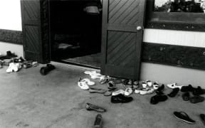 Shoes outside a wharenui are a common sight. Photograph by Gil Hanly, source Te Ara: https://teara.govt.nz/en/photograph/41374/shoes-at-the-door-of-the-wharenui