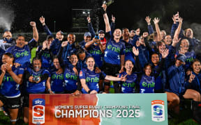 Maiakawanakaulani Roos (captain) of the Blues lifts the trophy as the Blues Women players celebrate winning the match, Blues Women v NSW Waratahs Women, Inaugural Women's Super Rugby Champions Final match at North Harbour Stadium.