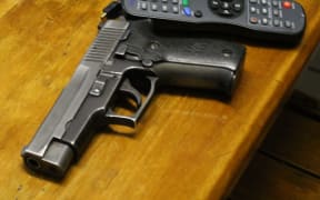 Gun on table.