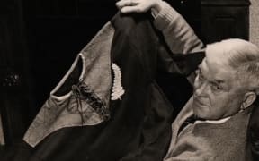 The late Arthur Goddard shows the All Blacks jersey he was given after his town's team Cheltenham played against New Zealand in 1905.