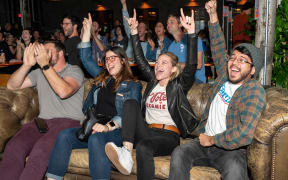 Supporters of Democratic presidential candidate Bernie Sanders cheer as they hear election results during a watch party.