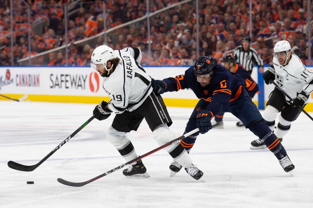 EDMONTON, AB - MAY 14: Cody Ceci #5 of the Edmonton Oilers defends Alex Iafallo #19 of the Los Angeles Kings during the first period in Game Seven of the First Round of the 2022 Stanley Cup Playoffs at Rogers Place on May 14, 2022 in Edmonton, Canada.