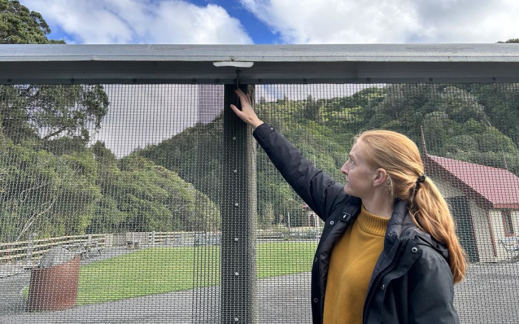 Jo Ledington points out her favourite part of the original Zealandia fence design which stops mice looping their tails around the bolts to get up and over.