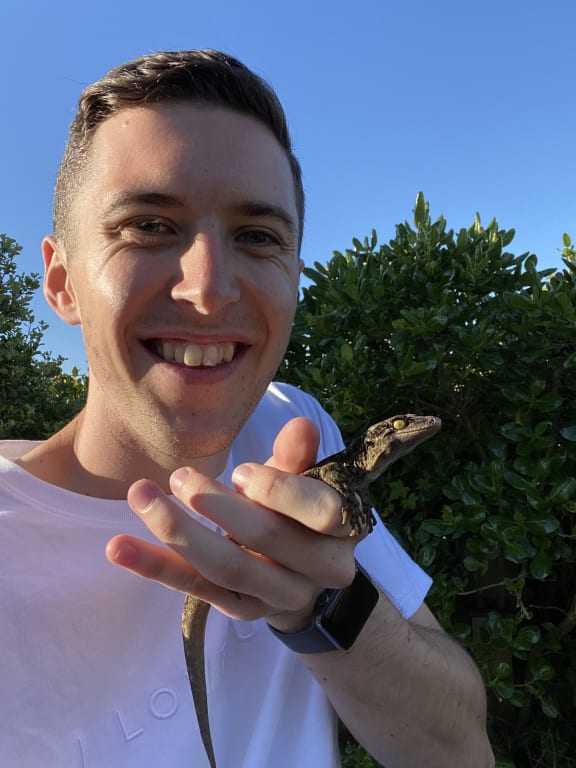 Researcher Lachie Scarsbrook with Duvaucel's gecko.