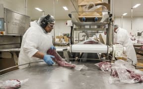Workers at Alliance Group process meat.