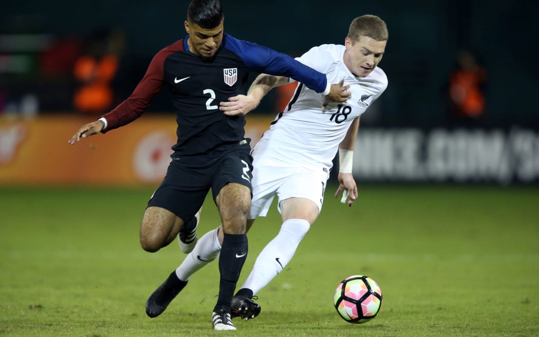 All White Kip Colvey battles for the ball with USA's DeAndre Yedlin during the two sides 1-all draw.