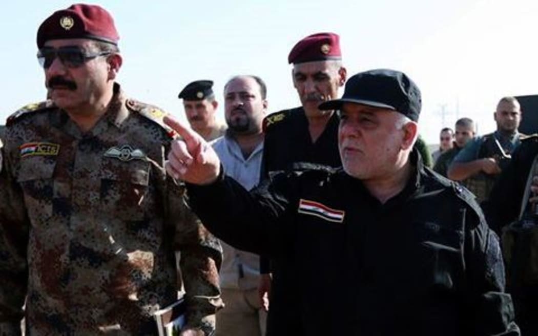 Iraqi Prime Minister Haider al-Abadi inspects the Iraq army's positions with his generals during the operation to retake Mosul.