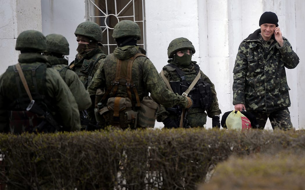 A Ukrainian soldier leaves the navy base in Novoozerne.