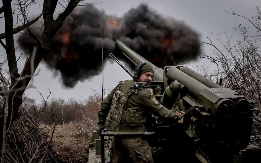 A serviceman of 24th Mechanised Brigade of the Ukrainian Armed Forces fires a 2s5 "Hyacinth-s" self-propelled howitzer towards Russian troops at a front line.