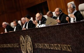 International Court of Justice president Ronny Abraham, second right, examines a document during a court case in December 2015.