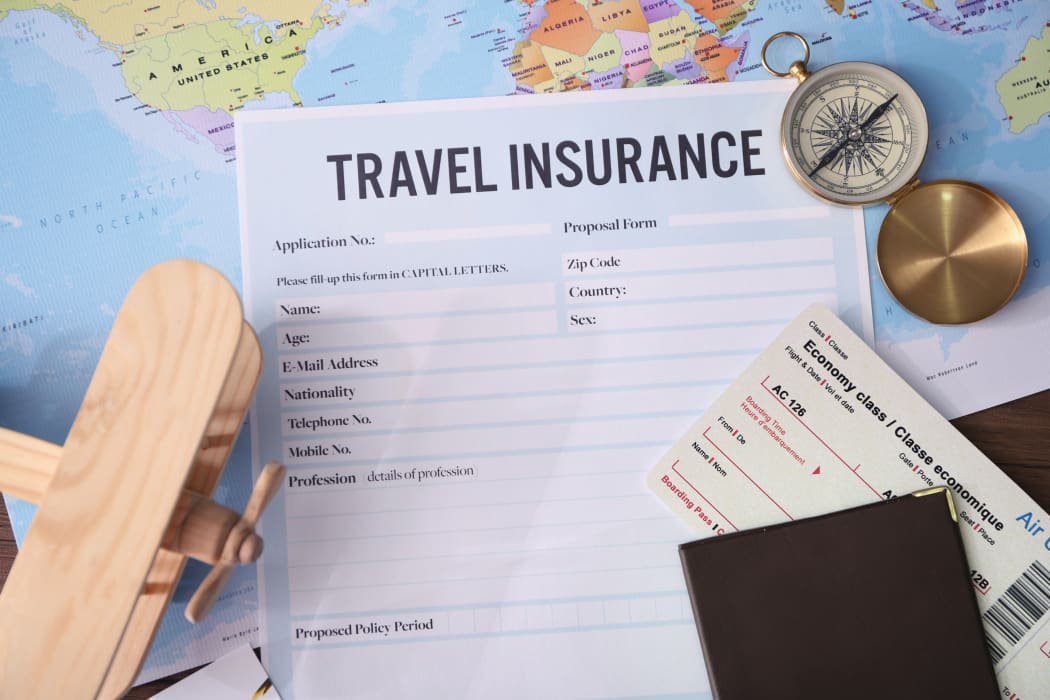 Blank travel insurance form and map on background