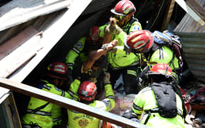 Rony Pu is rescued alive after a landslide at Cambray village