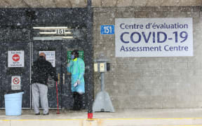 An Ottawa Public Health officer talking to a patient at a Covid-19 testing center in Ottawa, Canada.
