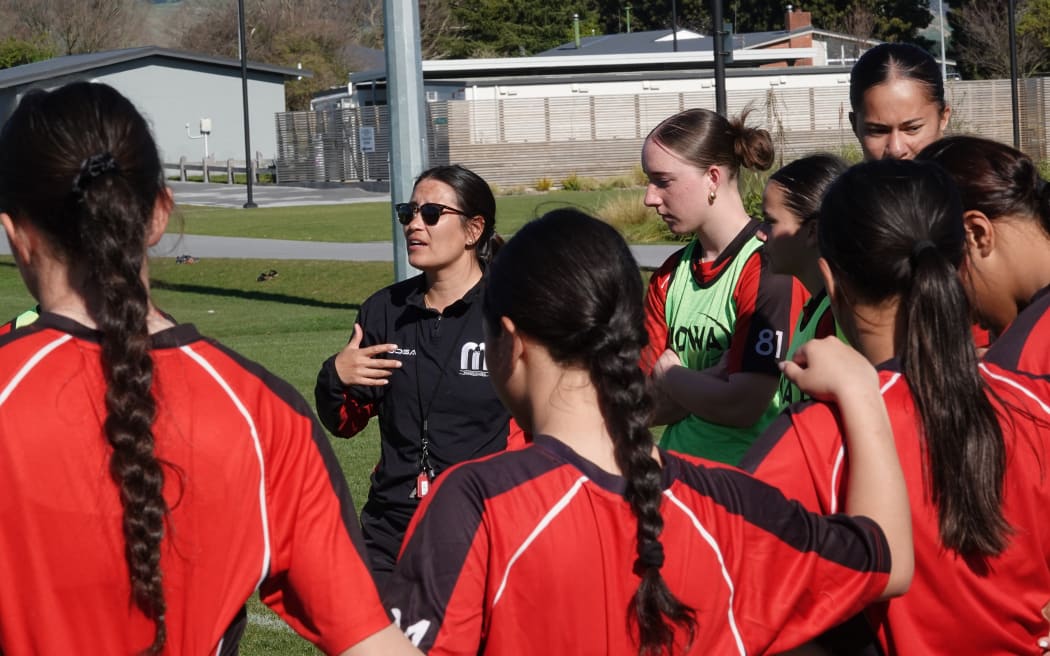 Kristina Sue leads a post-training debrief ahead of this weekend's semi final.