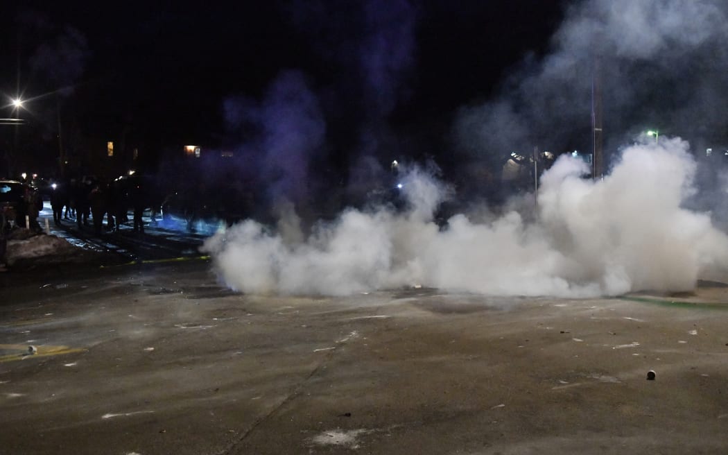 Federal law enforcement agents and police officers in riot gear use smoke crowd-control devices to disperse protesters following the shooting of a Venezuelan man by a Immigration and Customs Enforcement (ICE) agent in Minneapolis, Minnesota, on January 14, 2026. A federal immigration agent shot a man January 14 in Minneapolis, city officials said, urging the public to "remain calm" a week after agents shot and killed an American woman in the same city.
Minneapolis Police Chief Brian O'Hara said the shooting resulted from a struggle in front of a residence between a man and an Immigration and Customs Enforcement (ICE) agent on the north side of the city. (Photo by Octavio JONES / AFP)