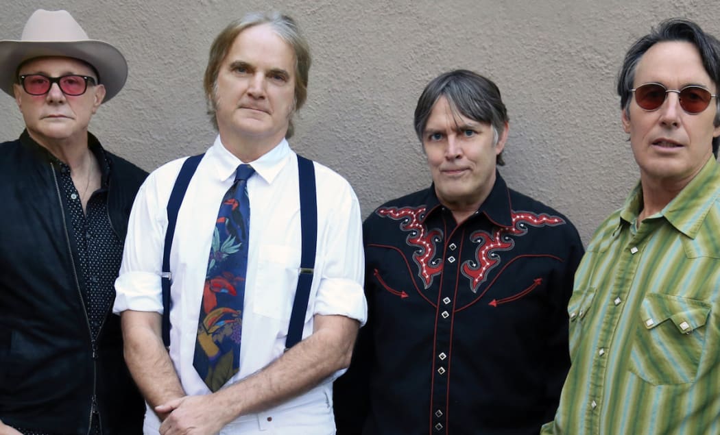 The American band The Long Ryders pictured in their finery against a stucco wall